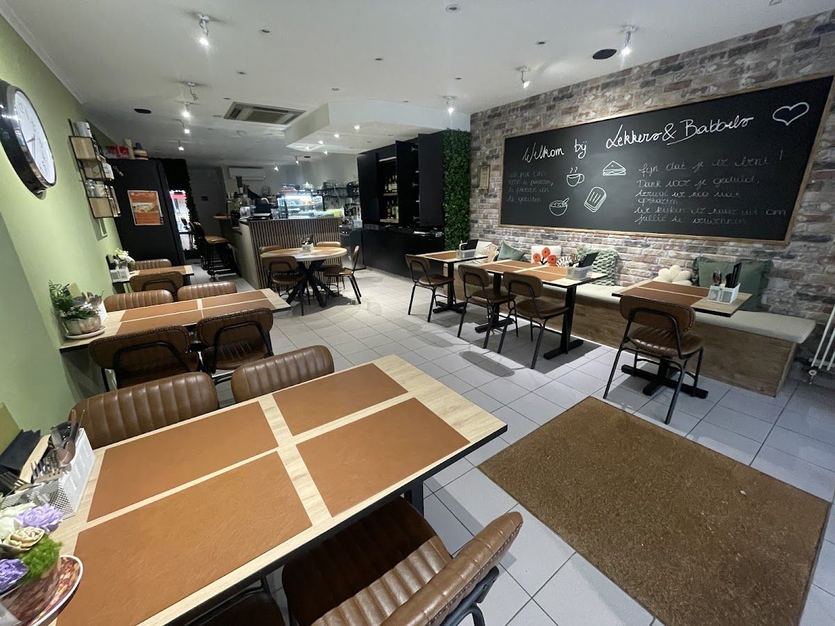 Gezellig interieur van Lekkers & Babbels in Scherpenheuvel — tafels met leerstoelen en krijtbord aan de muur